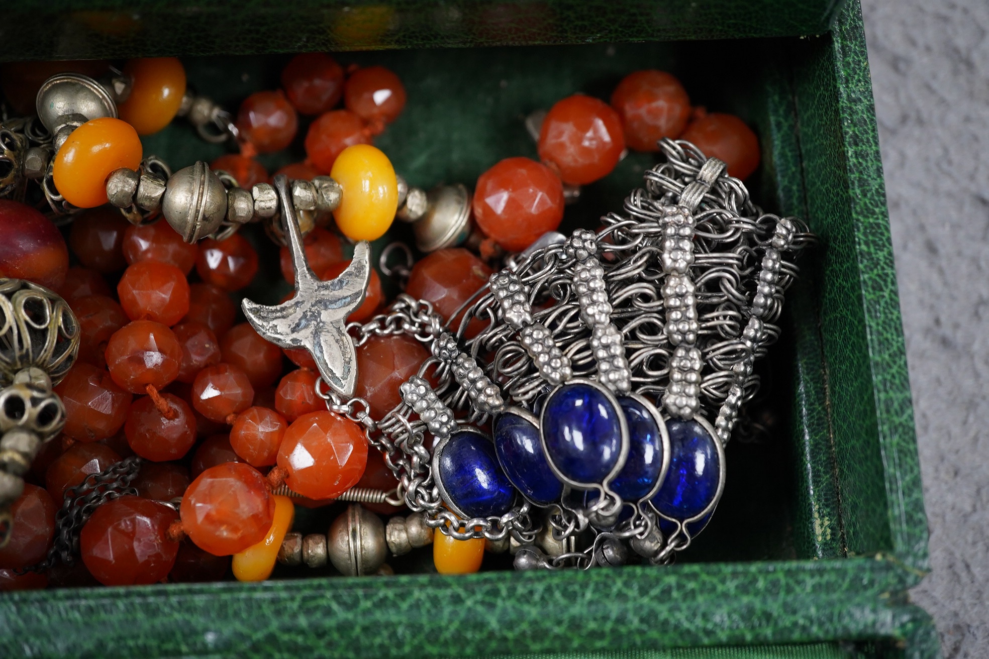 A quantity of assorted mainly costume jewellery in two boxes, including a coral bead necklace. Condition - poor to fair